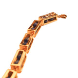 Angled product shot of gold box link bracelet with lapis lazuli beads