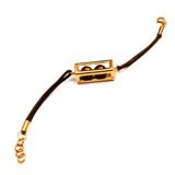 Large gold box motif on dark leather cord bracelet on white background