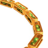 Close detail of large gold box link necklace showing open malachite bead compartments