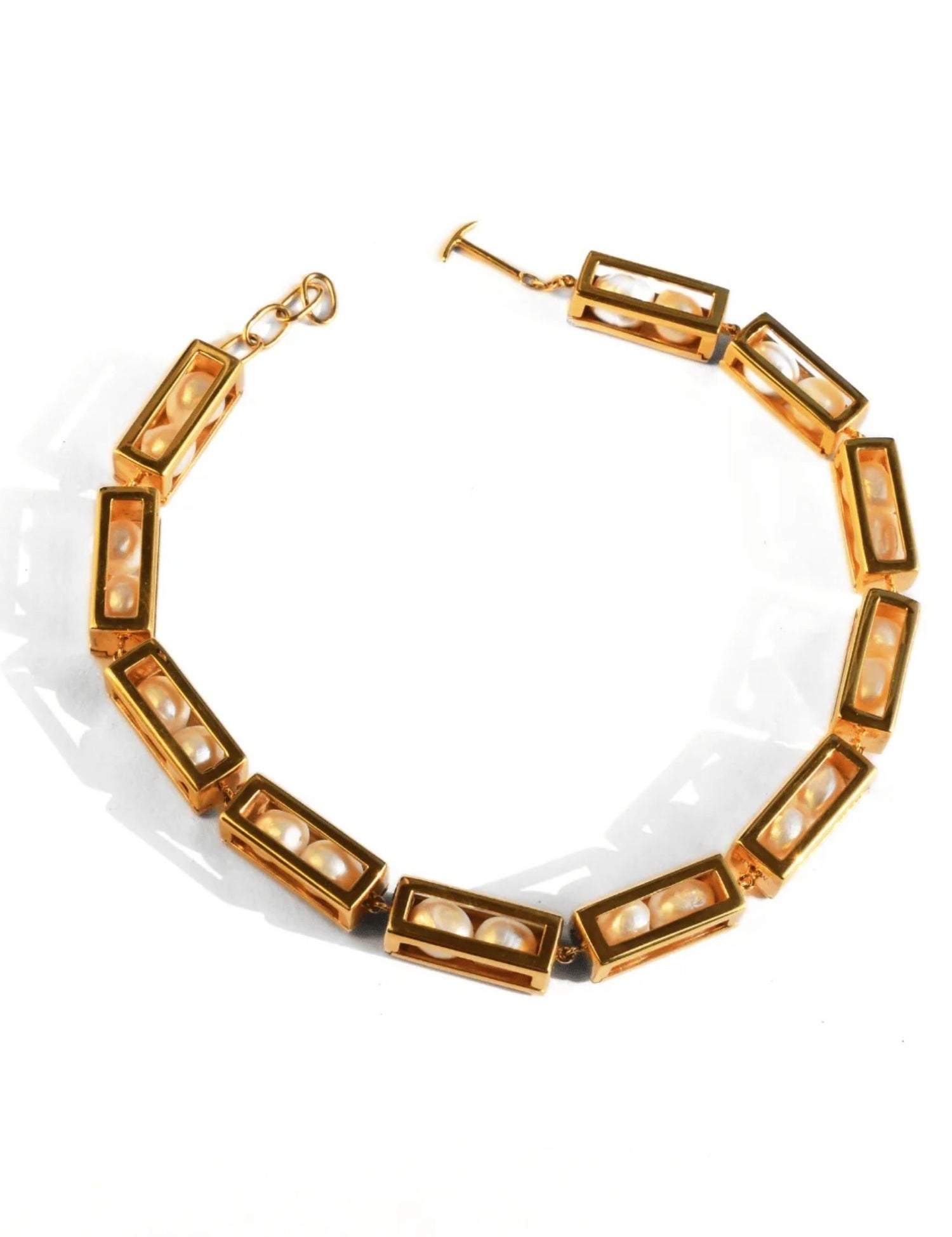Large gold box link choker necklace with pearl beads on white background