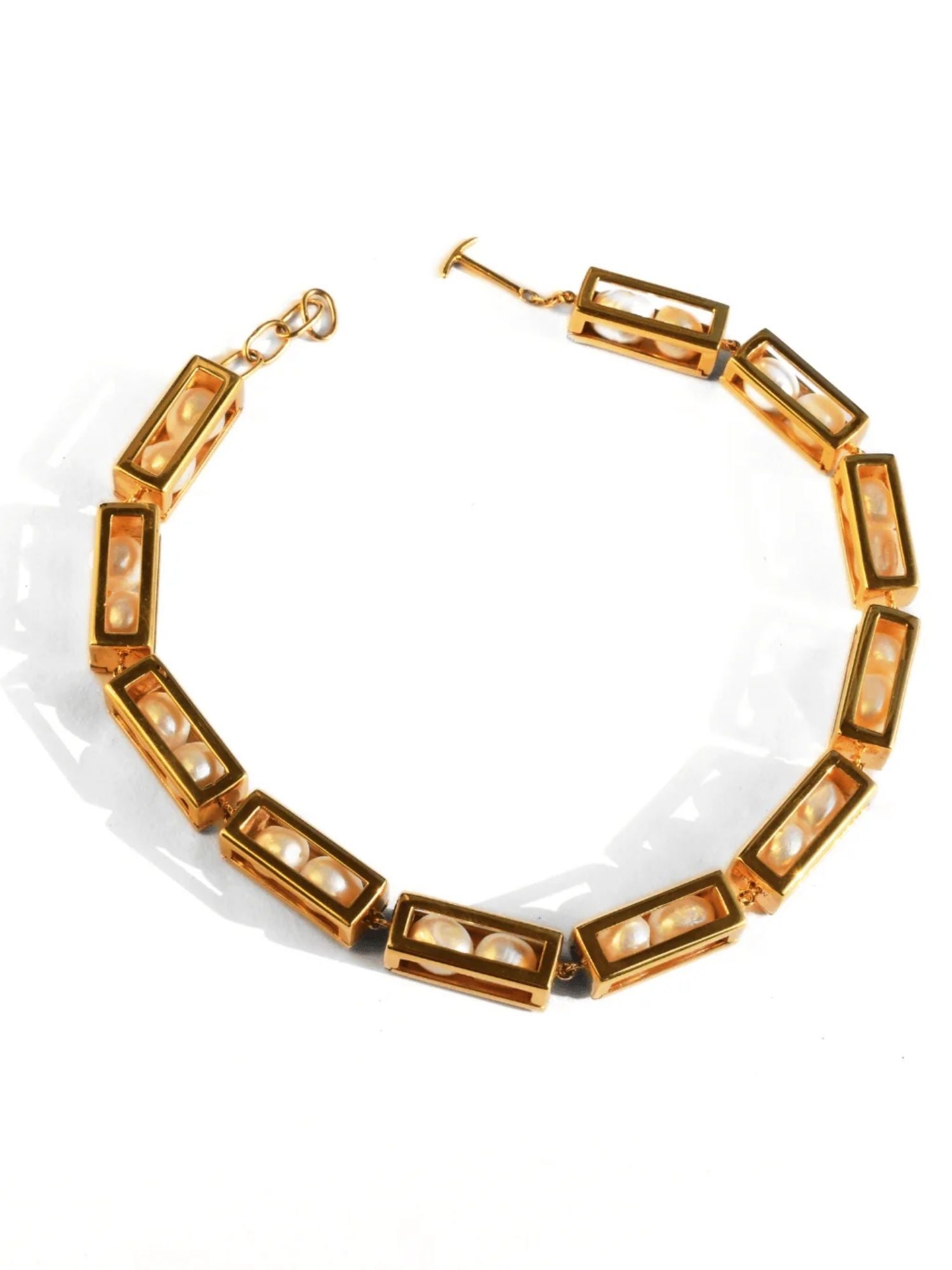 Large gold box link choker necklace with pearl beads on white background