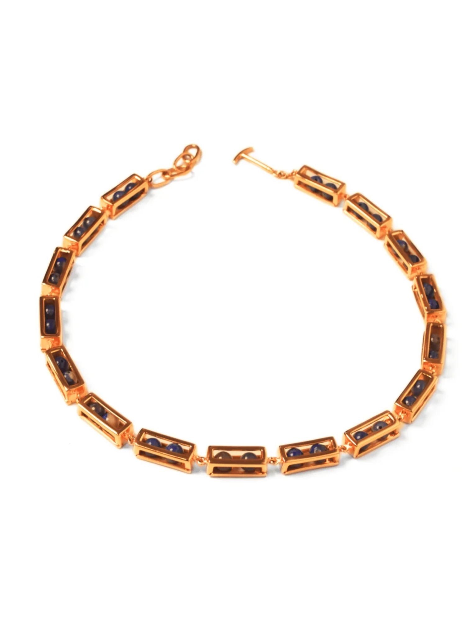 Flat lay of gold Fill Me In box link choker necklace with agate stone beads