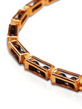 Close-up of open gold box link showing interchangeable bead mechanism