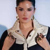 Model wearing large gold Fill Me In box ring stacked with other cocktail rings on both hands