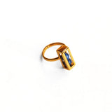Gold interchangeable box ring with lapis lazuli bead on white background
