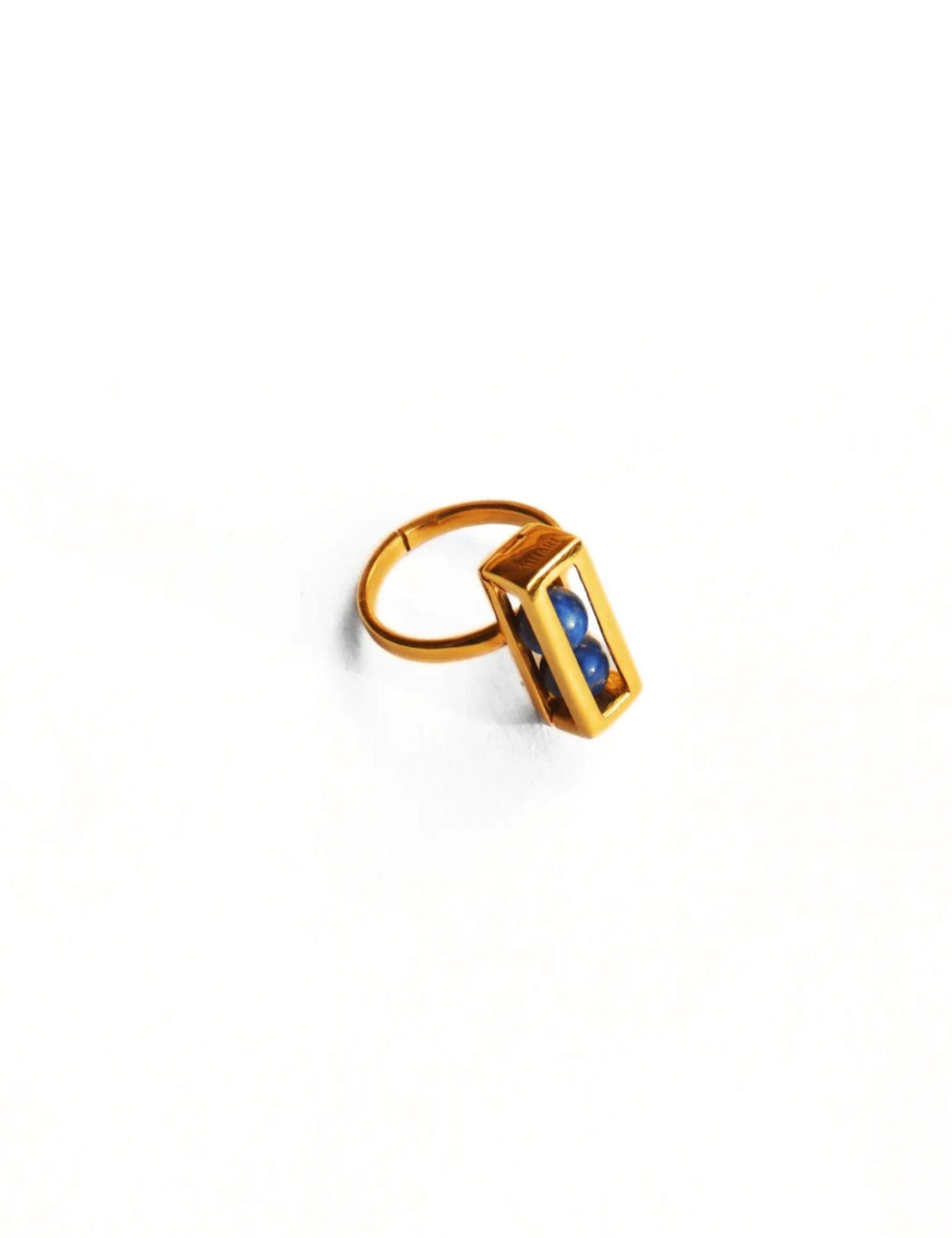 Gold interchangeable box ring with lapis lazuli bead on white background
