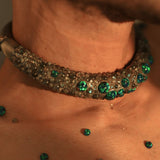 Green opal hasli necklace on male model's collarbone in warm close-up