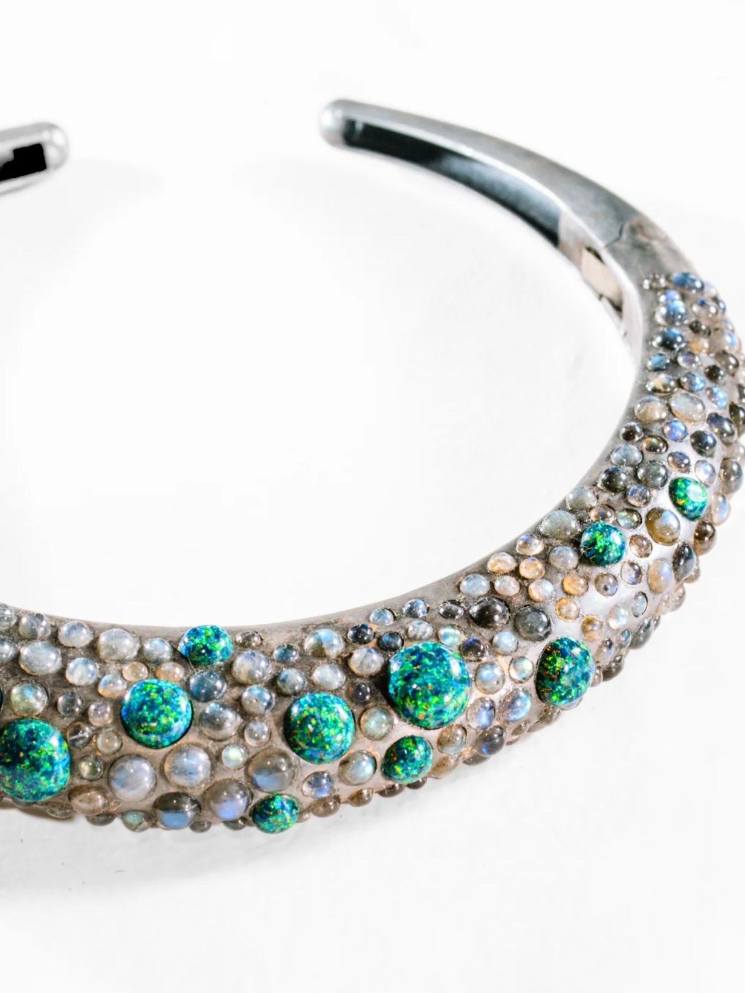 Detail shot of oxidised silver green opal hasli necklace showing stone texture