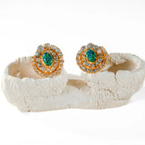 Green fire opal and labradorite spiral stud earrings on white sculptural prop