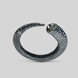 Close product shot of Irodori bangle showing teal zircon stone tip set in black oxidised silver.