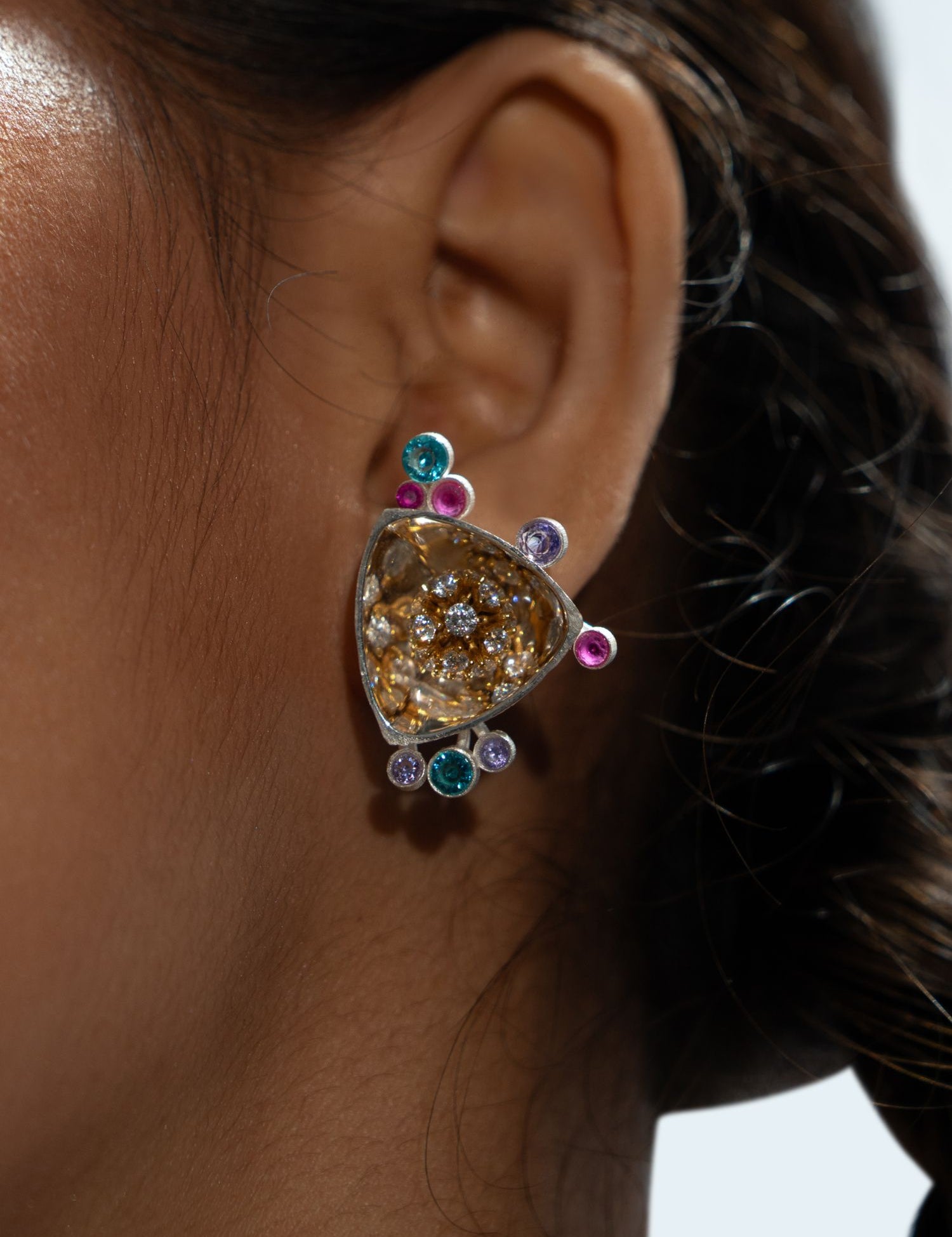Irodori Choker Earring with multistone zircon surround worn close to ear in warm editorial profile shot.