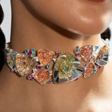 Irodori silver choker with multistone zircon clusters worn close to model's neck in warm editorial light.