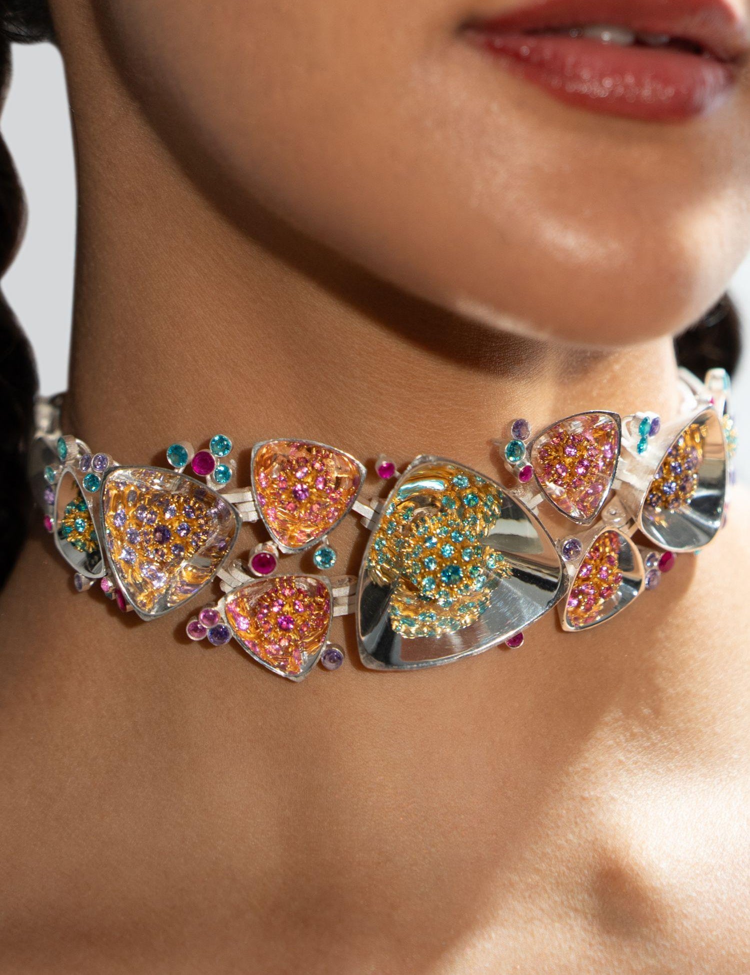 Irodori silver choker with multistone zircon clusters worn close to model's neck in warm editorial light.