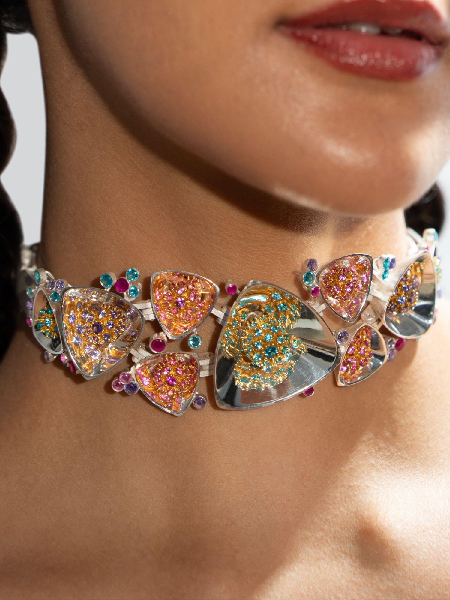 Irodori silver choker with multistone zircon clusters worn close to model's neck in warm editorial light.