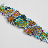 Close detail of Irodori choker showing amber orange and teal zircon cluster motifs in polished silver.