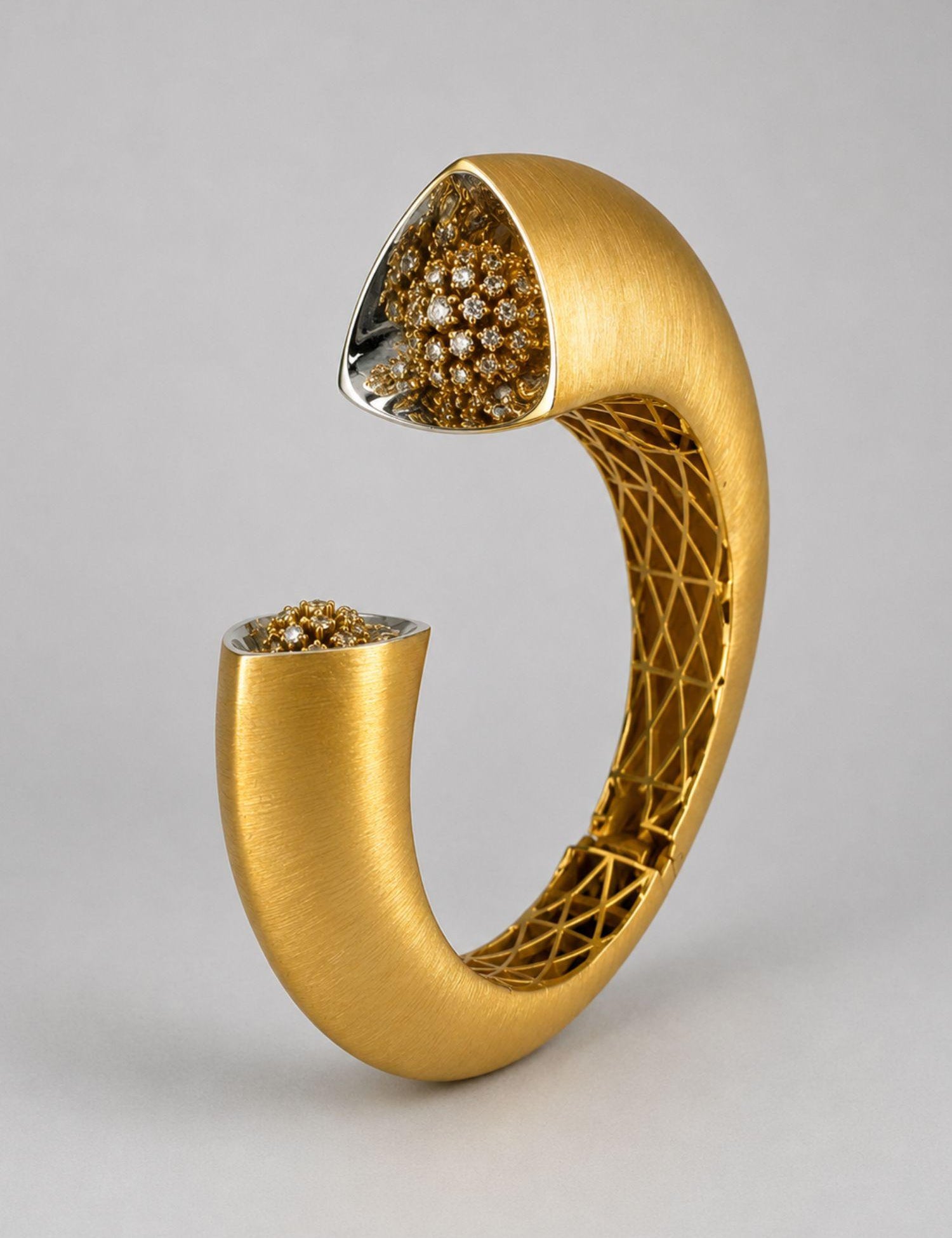 Close angled shot of Irodori gold cuff showing handcrafted lattice interior and CZ flower motif tip detail.