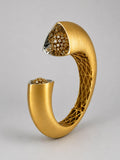 Close angled shot of Irodori gold cuff showing handcrafted lattice interior and CZ flower motif tip detail.