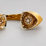 Extreme close-up of Irodori cuff motif tip showing CZ-set double flower detail in 24k gold.