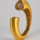 Side profile of Irodori Double Motif Cuff in 24k gold showing sculptural open form and CZ flower tip.