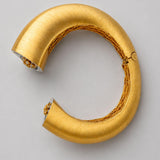 Top-down view of Irodori Double Motif Cuff in brushed 24k gold showing open cuff form and inner lattice.