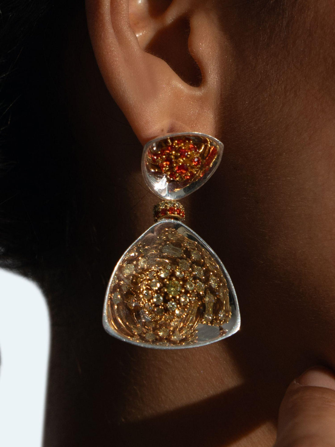 Irodori large drop earrings with amber zircon cluster top and triangular silver drop on neutral background.