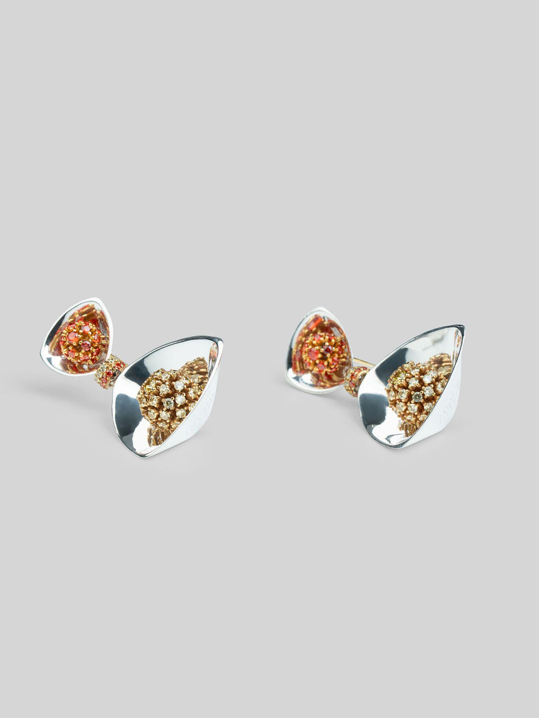 Irodori large drop earrings with amber zircon cluster top and triangular silver drop on neutral background.