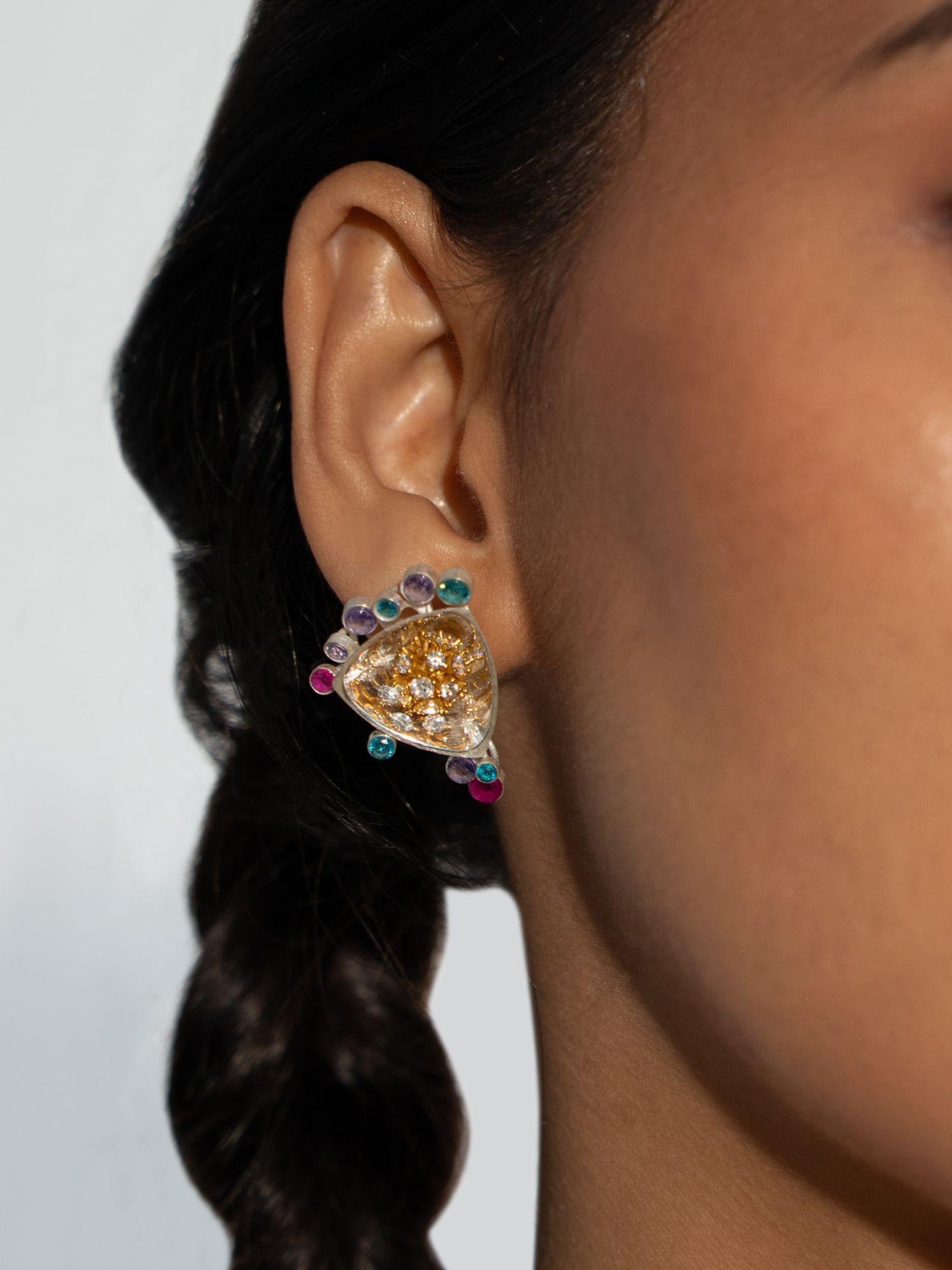 Side profile of Irodori Mix earring with teal and amber stone cluster worn close to model's ear.