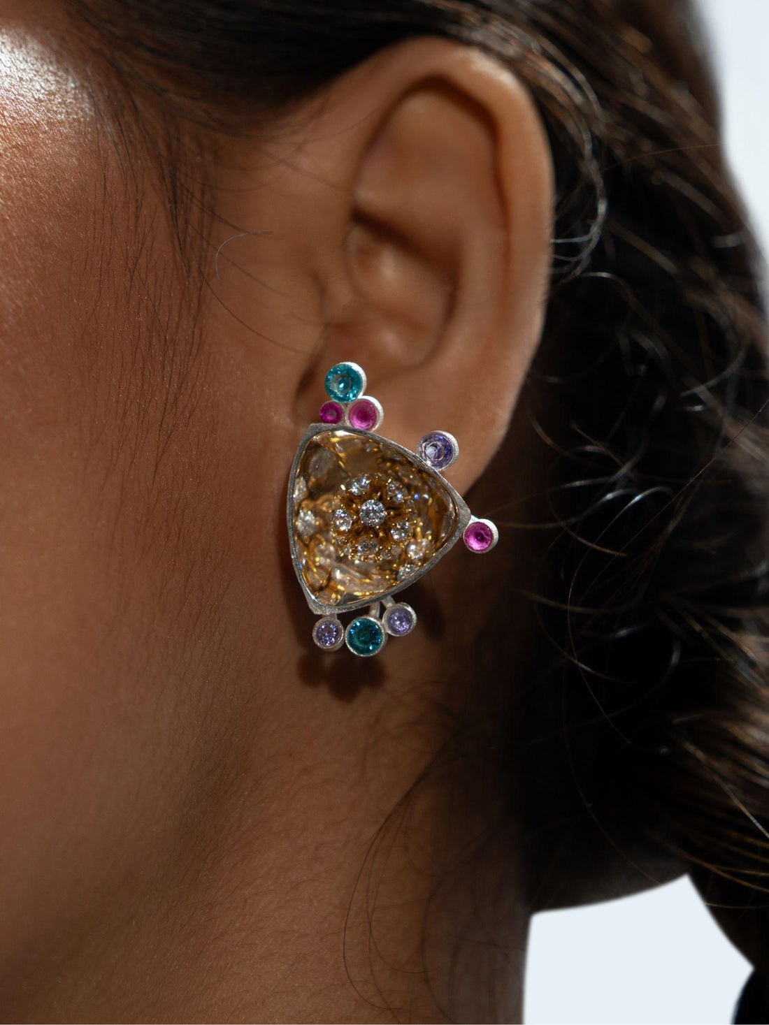 Irodori Mix earrings with amber zircon cluster and teal blue stone accents in silver on neutral background.