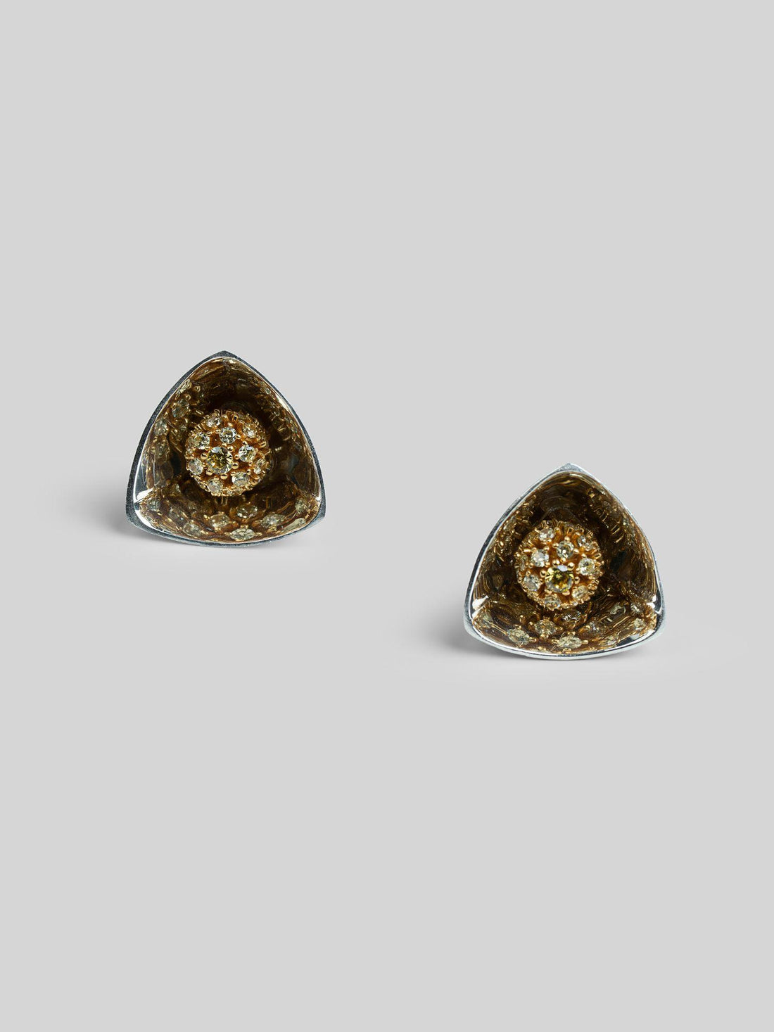 Irodori small triangular stud earrings with dark zircon cluster set in deep silver on neutral background.