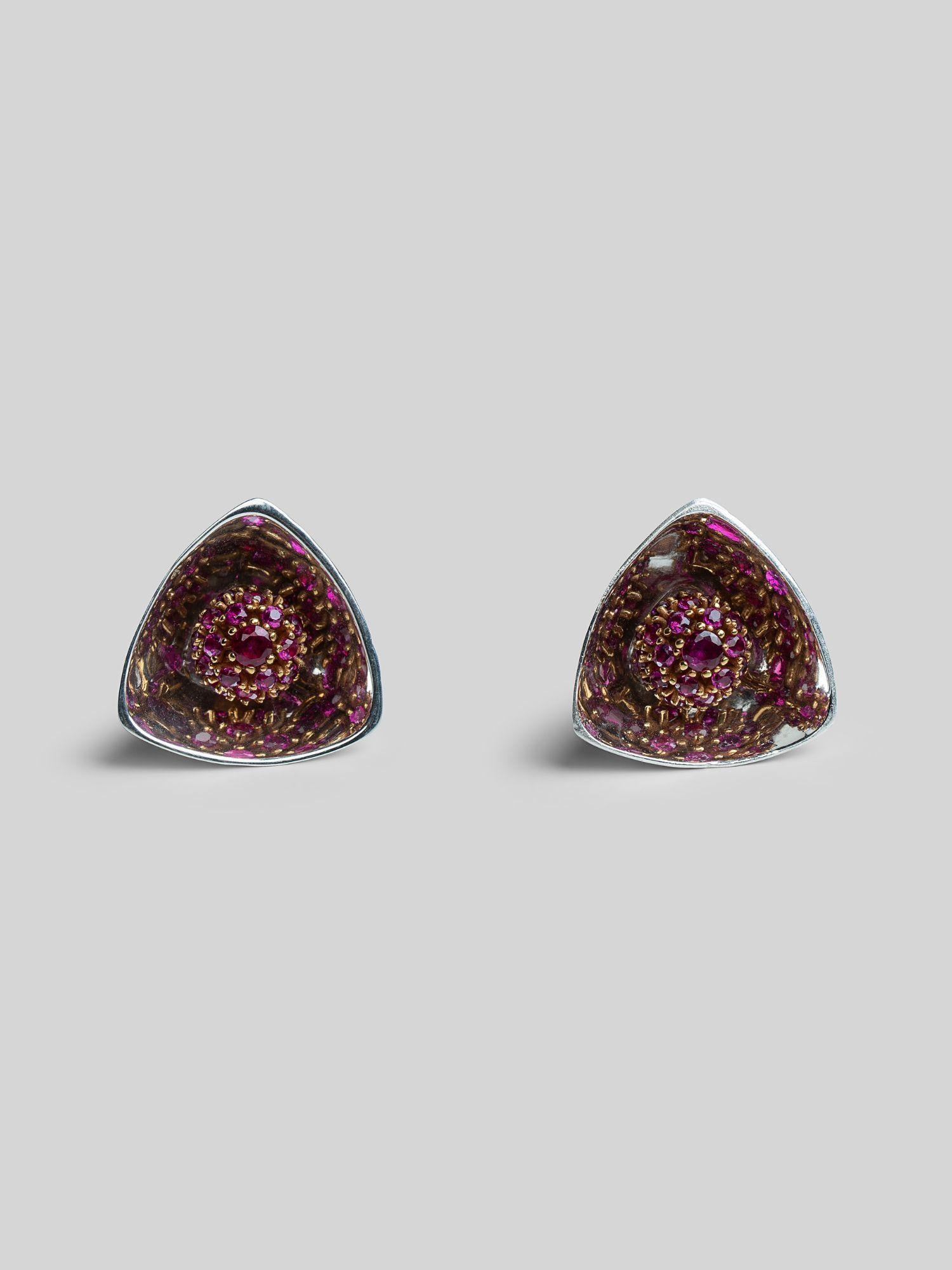Irodori small triangular stud earrings with pink ruby zircon cluster in silver on neutral background.