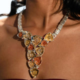 Irodori long necklace with zircon cluster pendants worn on model's décolletage in warm editorial light.