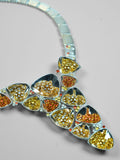 Close product shot of Irodori necklace showing amber and orange zircon cluster motifs in polished silver.