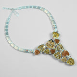 Irodori long statement necklace with mixed zircon cluster pendants in silver on neutral background.