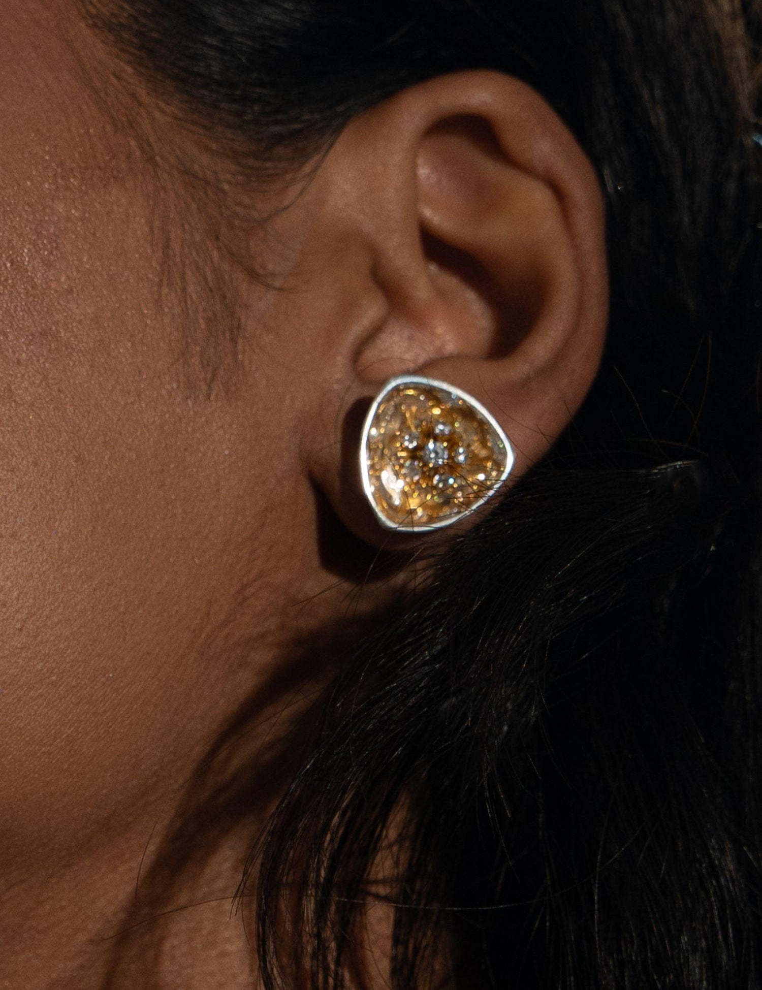 MHARI Irodori Small gold zircon statement earring worn on ear, mirror-polished 925 silver