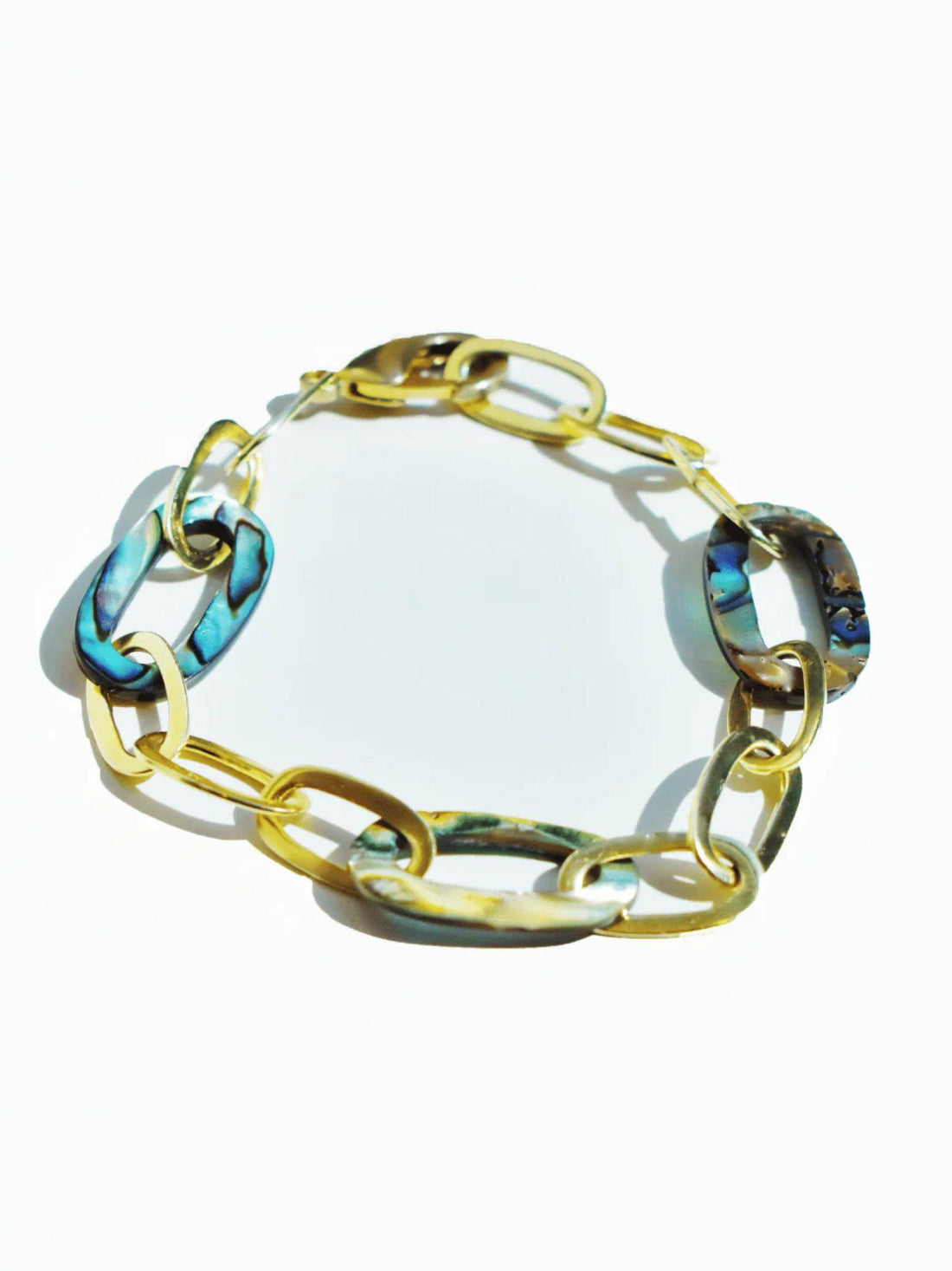 Abalone and gold link chain bracelet on white background, blue-green stones
