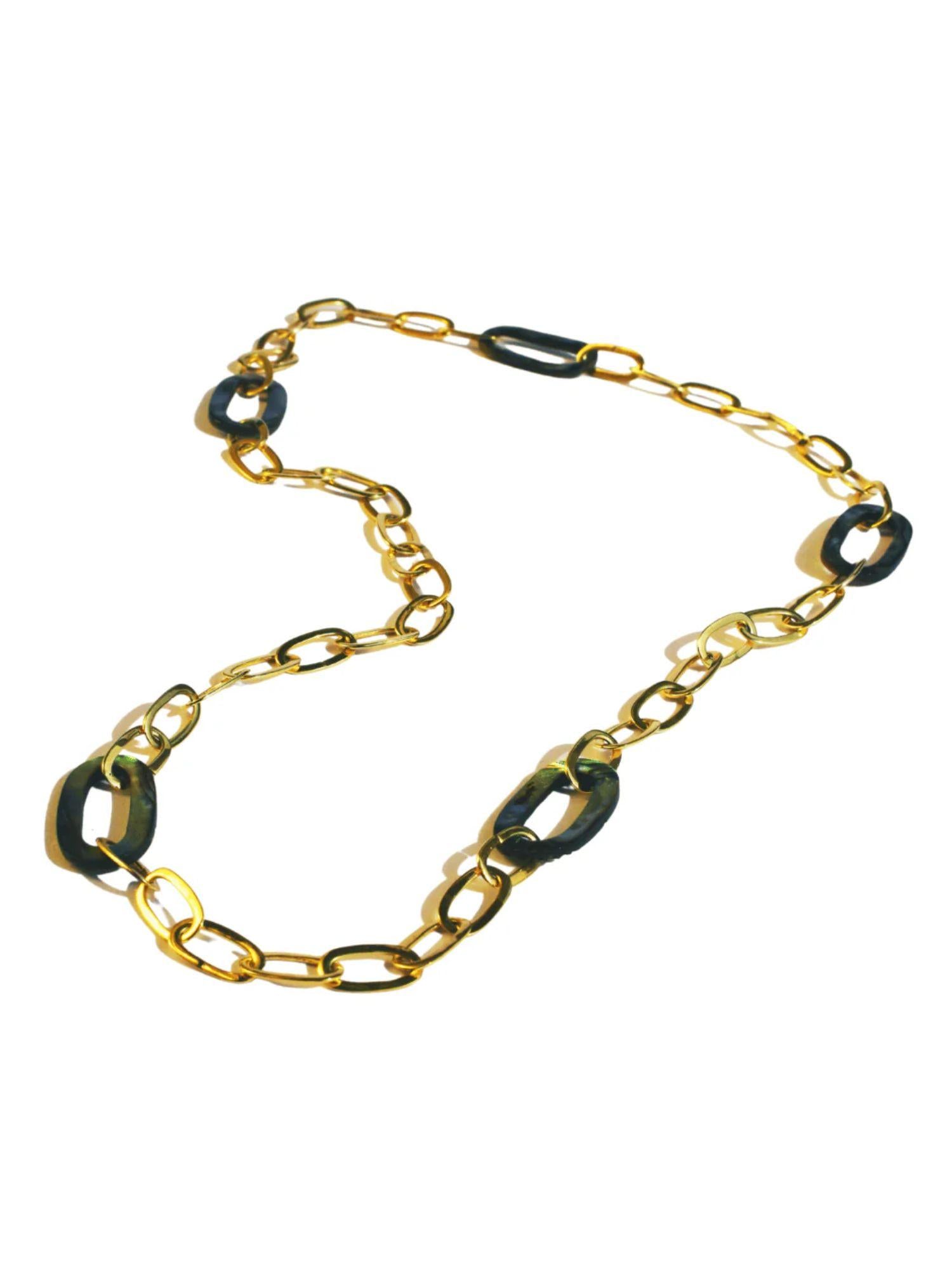 Gold oval link chain necklace with abalone stone links on white background