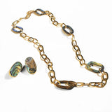 Gold link chain necklace with abalone stone set and small earrings on white