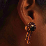 Kōmon keyhole statement earring with black spinel centre and amethyst worn close to ear on model.
