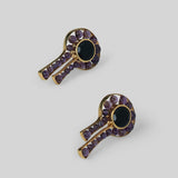 Angled product shot of Kōmon keyhole earrings showing circular spinel form and drop detail in gold.