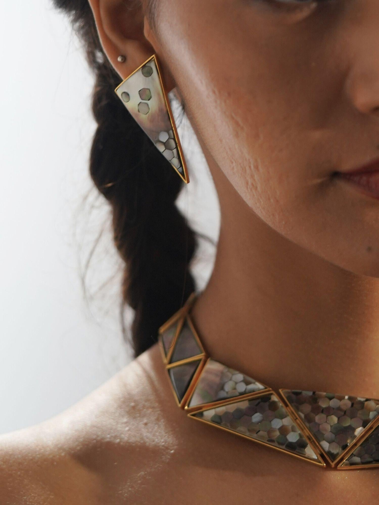 Mosaic earrings and necklace set worn together in warm profile editorial, full abalone detail visible.