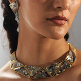 Model wearing Mosaic abalone necklace front-on, hexagon tiles catching light in editorial portrait.
