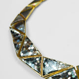 Close product shot of Mosaic necklace showing abalone hexagon tile and 24k gold frame detail.