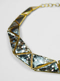 Close product shot of Mosaic necklace showing abalone hexagon tile and 24k gold frame detail.