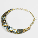 Mosaic statement necklace with handcrafted abalone and mother of pearl hexagon tiles in gold.
