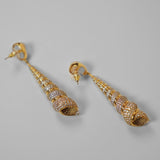 Neris shell drop earrings with pearl stud and spiral shell form in 24k gold on neutral background.