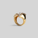 Noira sculptural cocktail ring with natural pearls and zircons in 24k gold on neutral background.