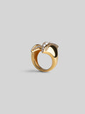 Noira sculptural cocktail ring with natural pearls and zircons in 24k gold on neutral background.