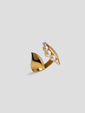 Side view of Noira pearl ring showing sculptural gold form with natural pearl detail.