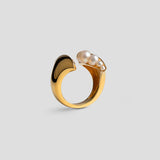 Top-down view of Noira cocktail ring with natural pearls set in open sculptural 24k gold band.