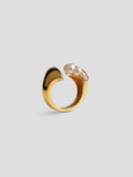 Top-down view of Noira cocktail ring with natural pearls set in open sculptural 24k gold band.